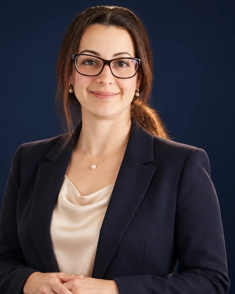 Michelle Newman | CAQA Groups A professional woman wearing glasses and a navy blazer smiles at the camera, representing CAQA Groups' leadership in vet.
